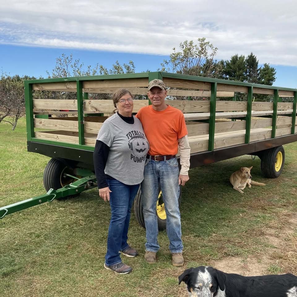 The Conine family by a hayride wagon